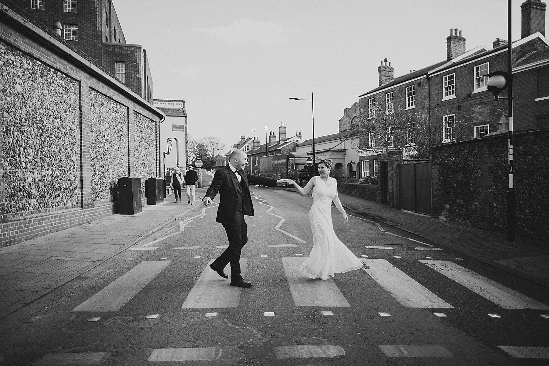 bride and groom walking across the road in bury st edmunds