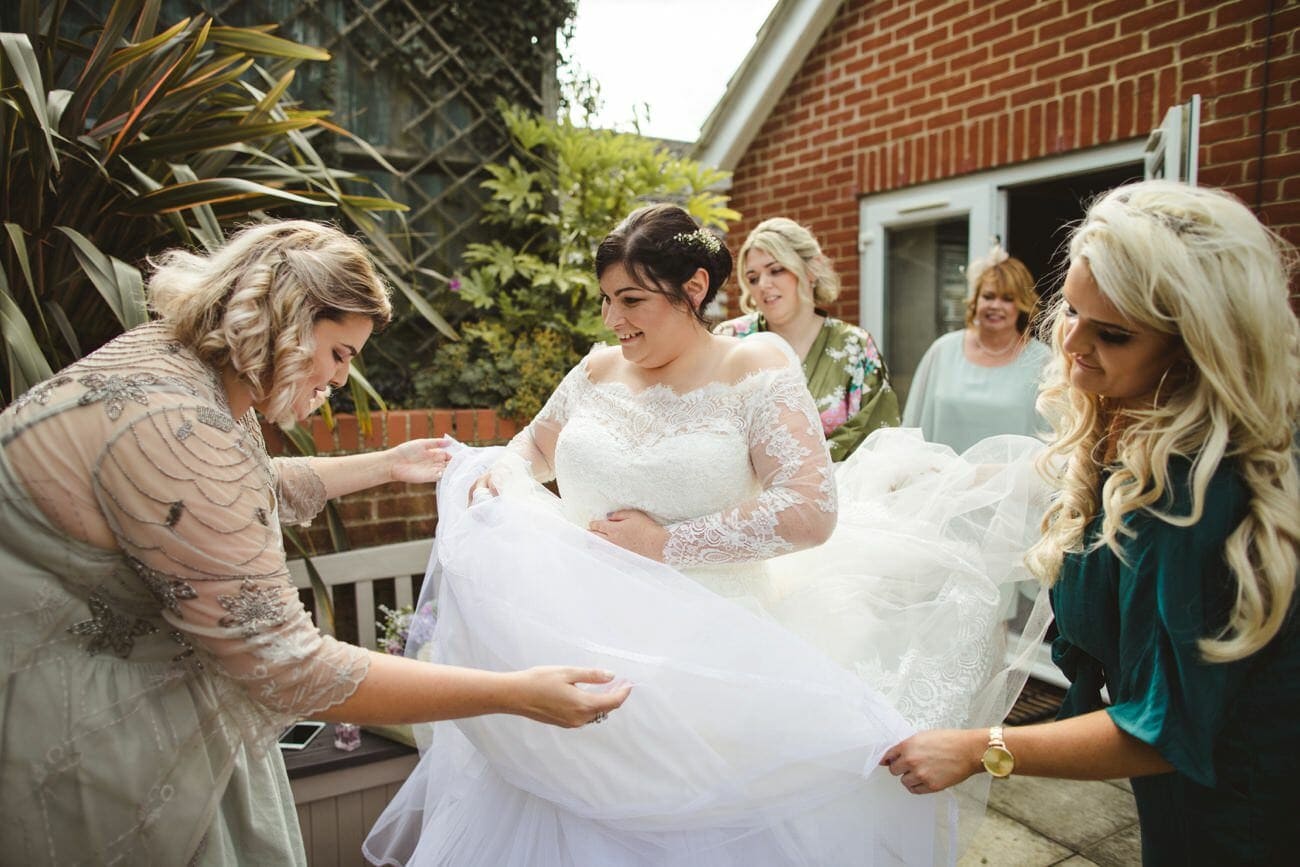 Halstead wedding photography bridal preps bride getting in her dress