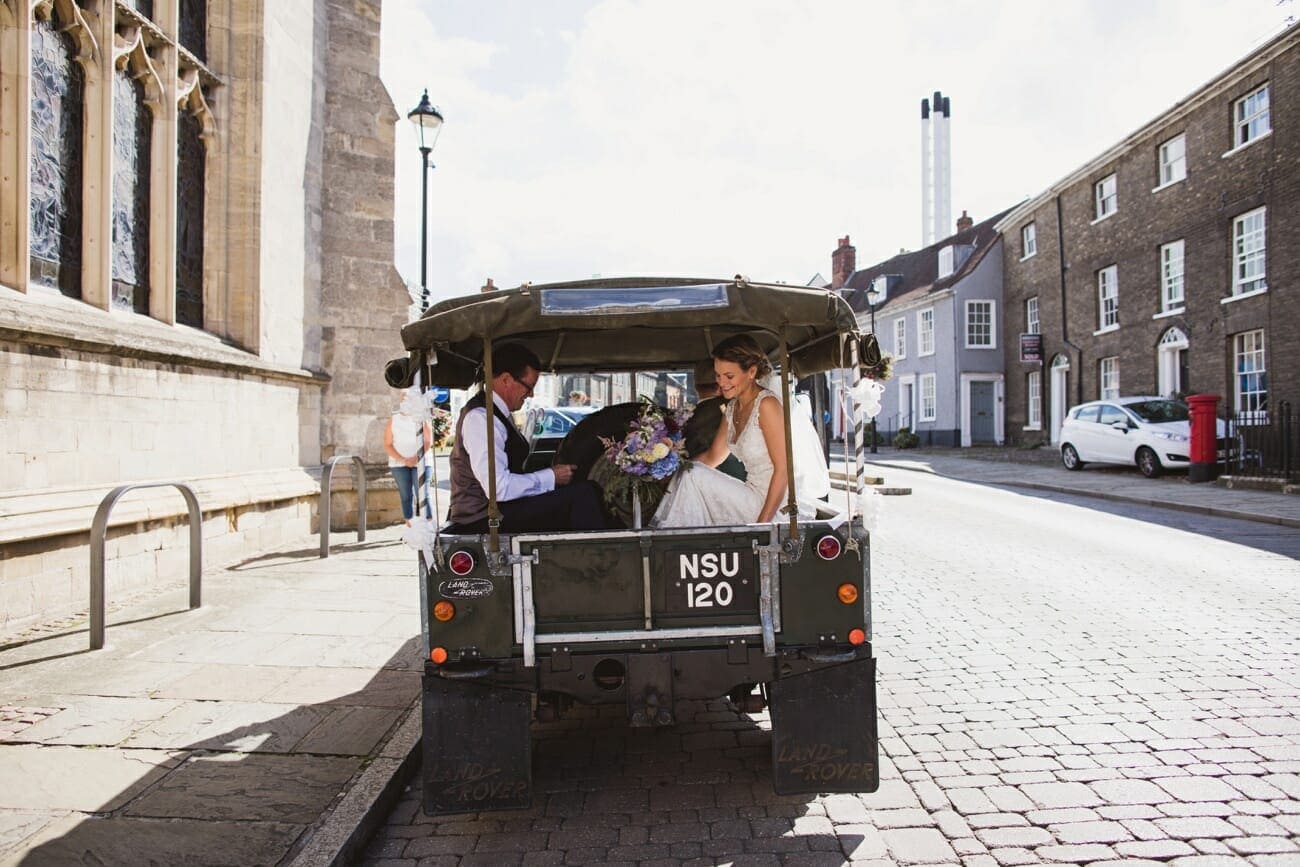St Mary's Church Bury St Edmunds Bride arriving in old land rover