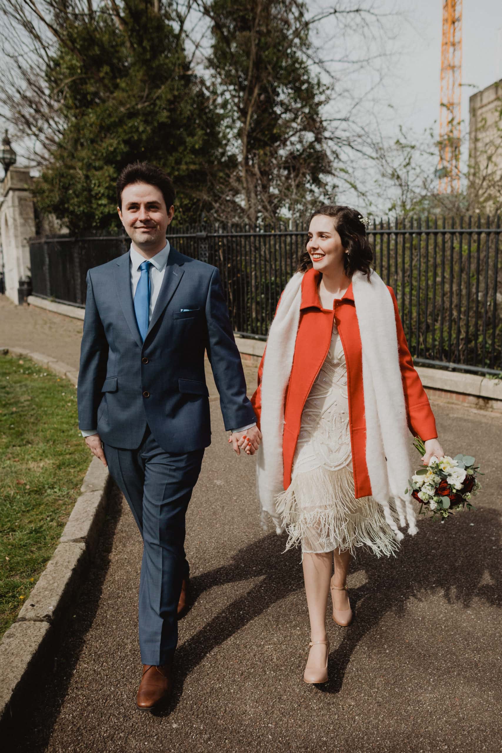 bride and groom walking from norwich castle wedding