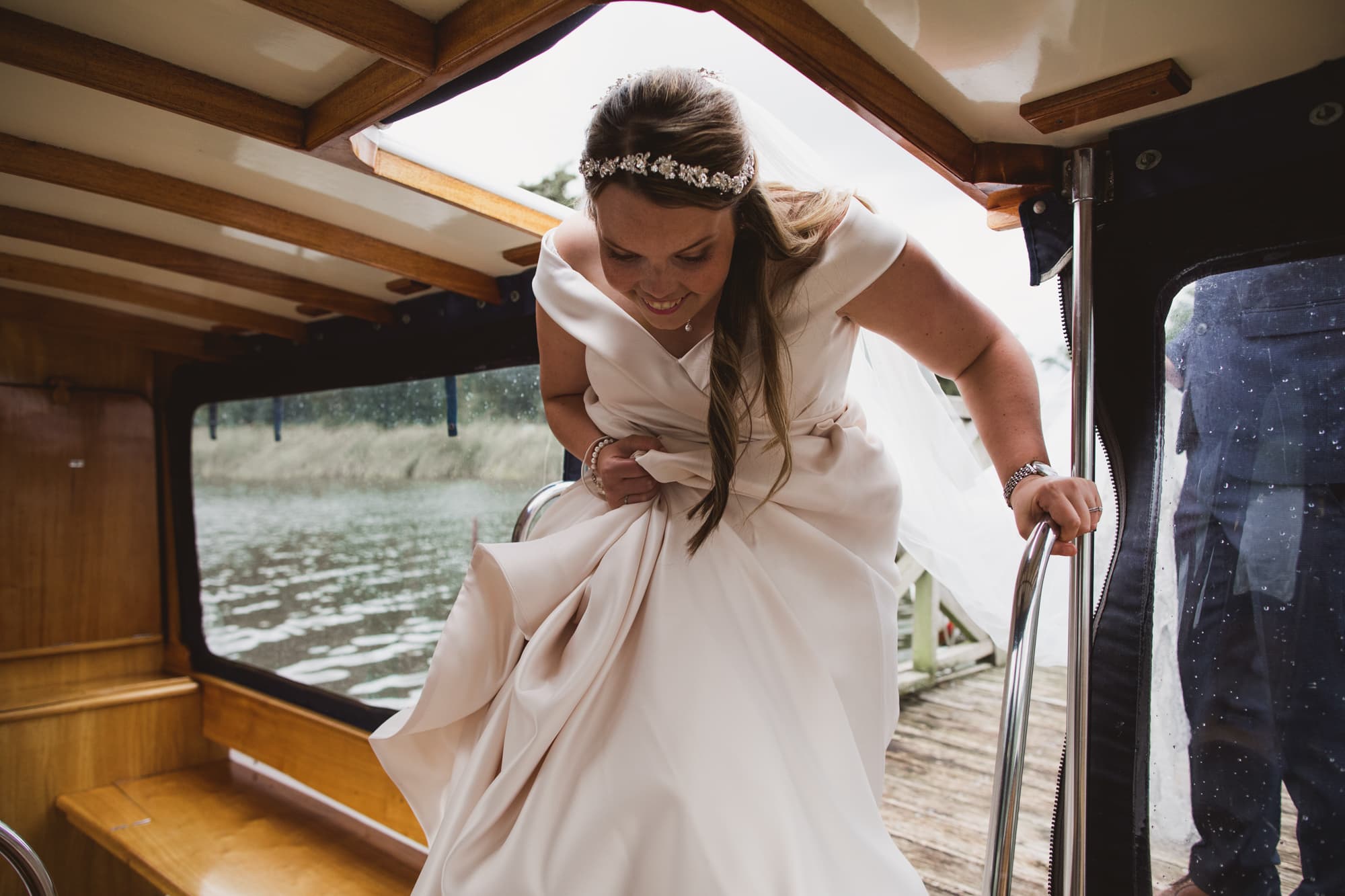 bride getting on the boat for a ride around the broads
