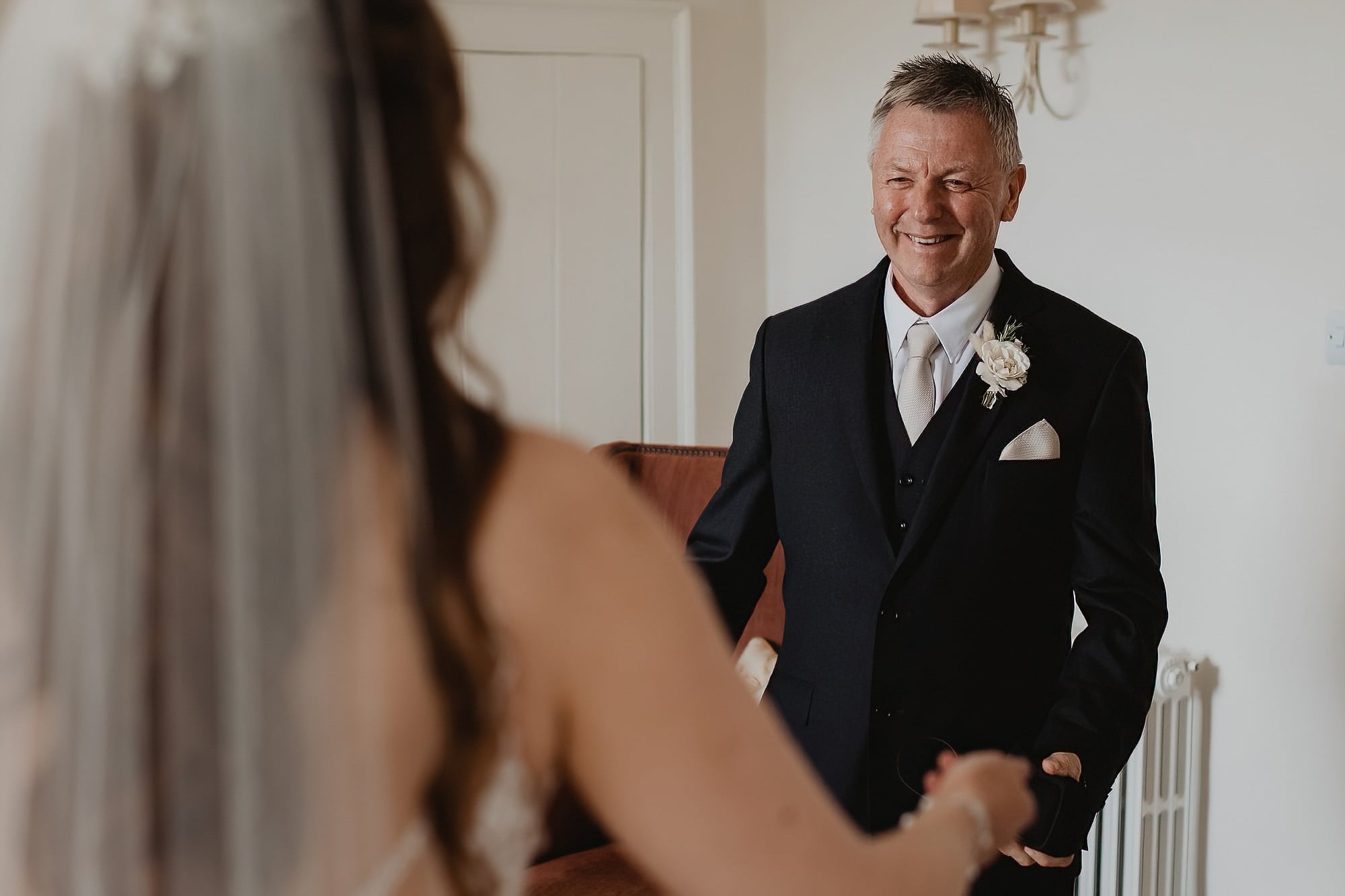 brides dad seeing his daughter for the first time in wedding dress