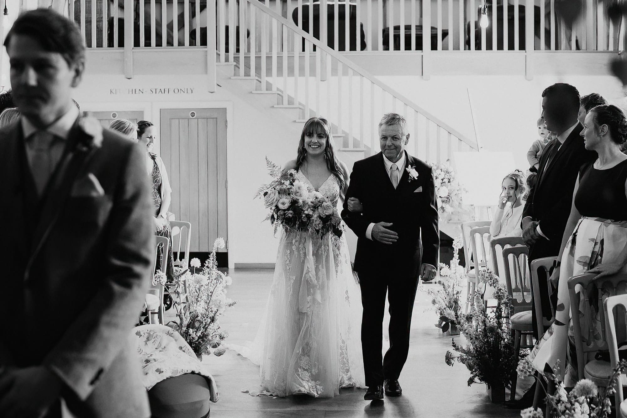 bride walking up the aisle with her dad
