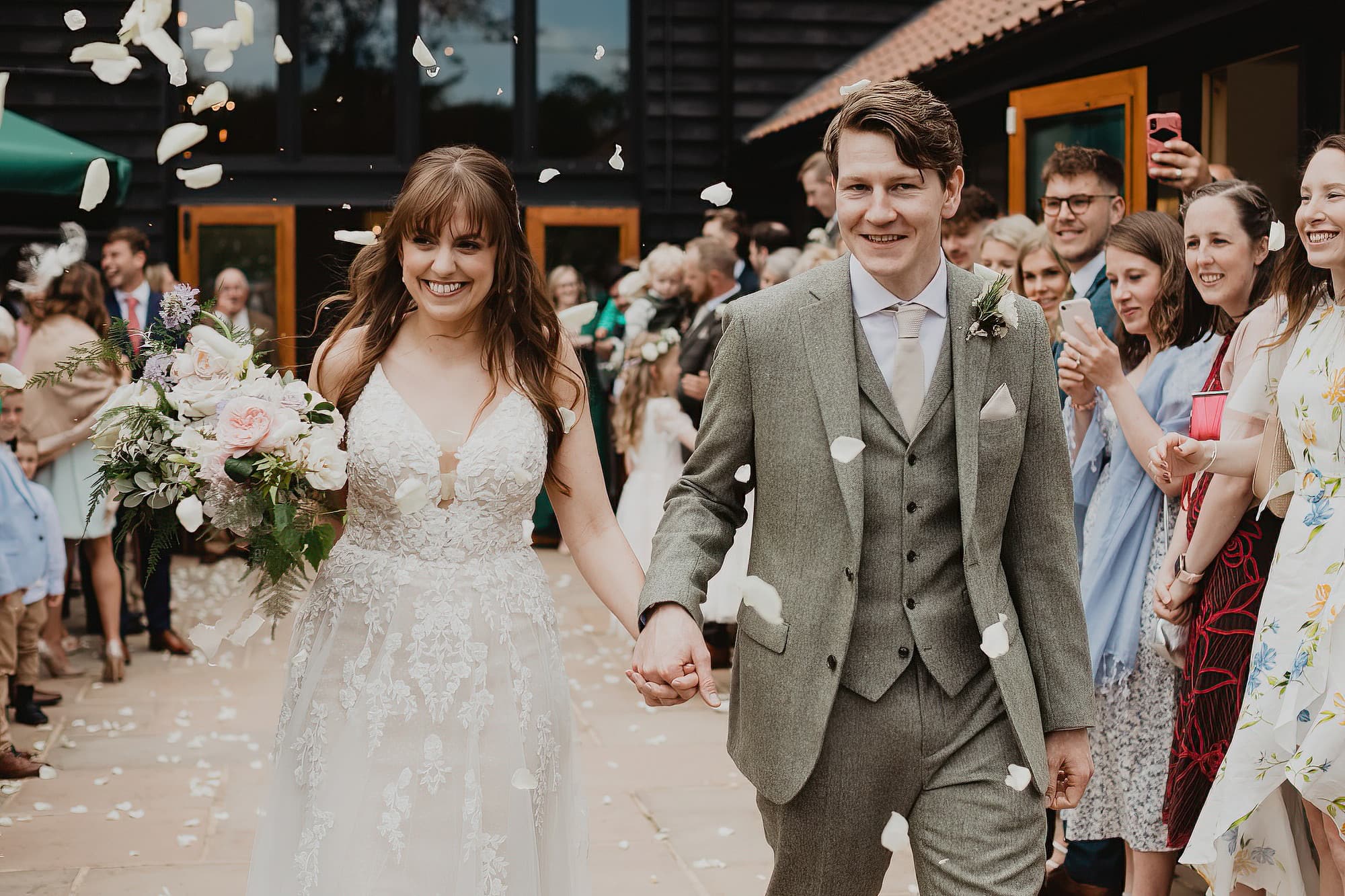 bride and groom walking through confetti