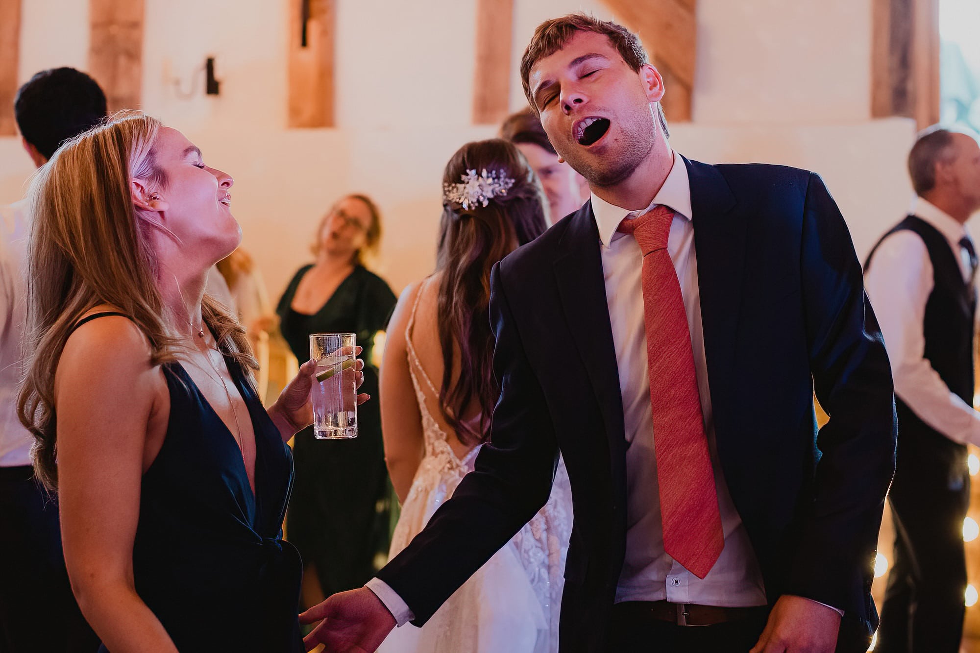 guests singing and dancing at wedding reception