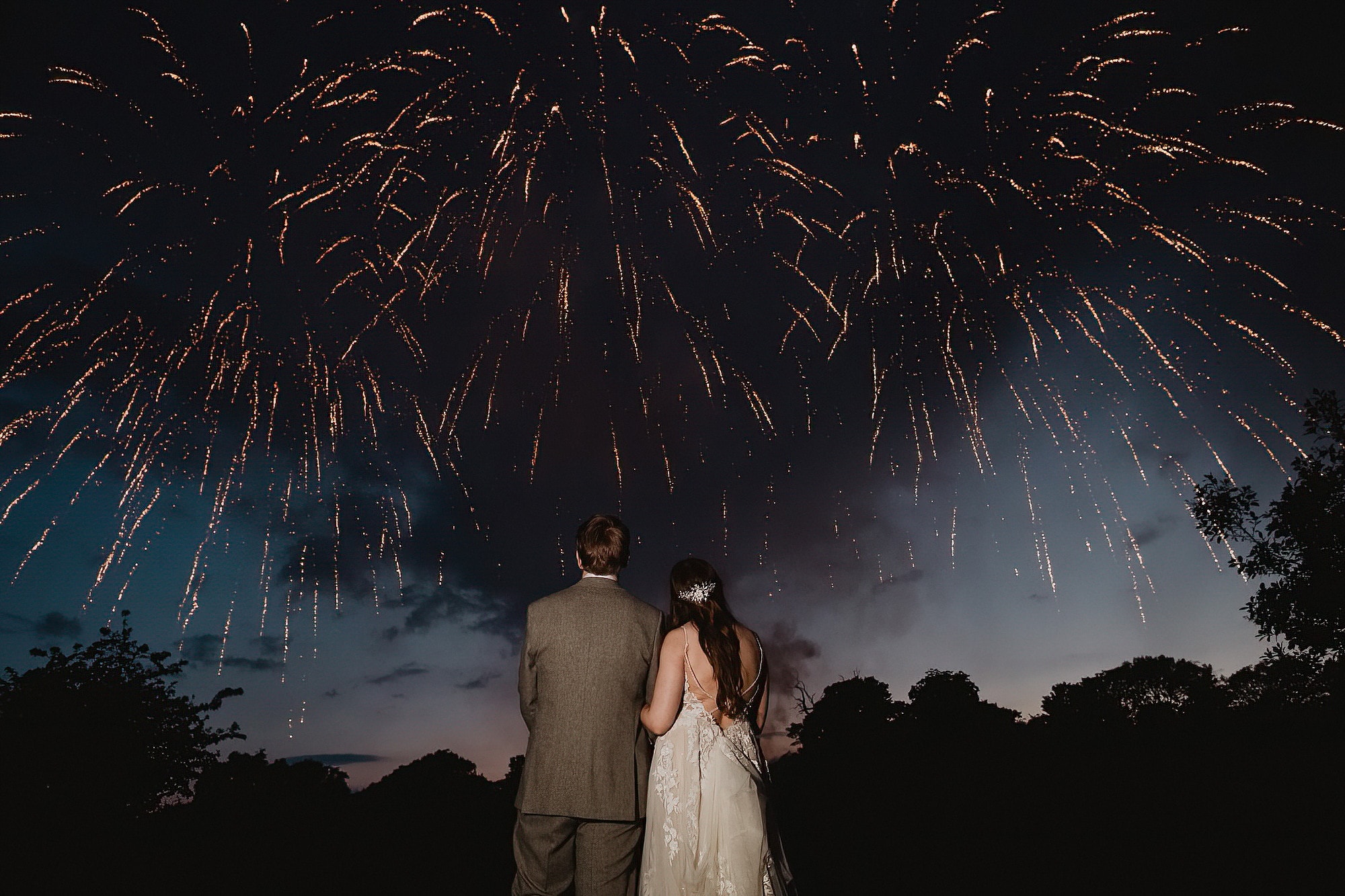 bride and groom watching fireworks at bruisyard