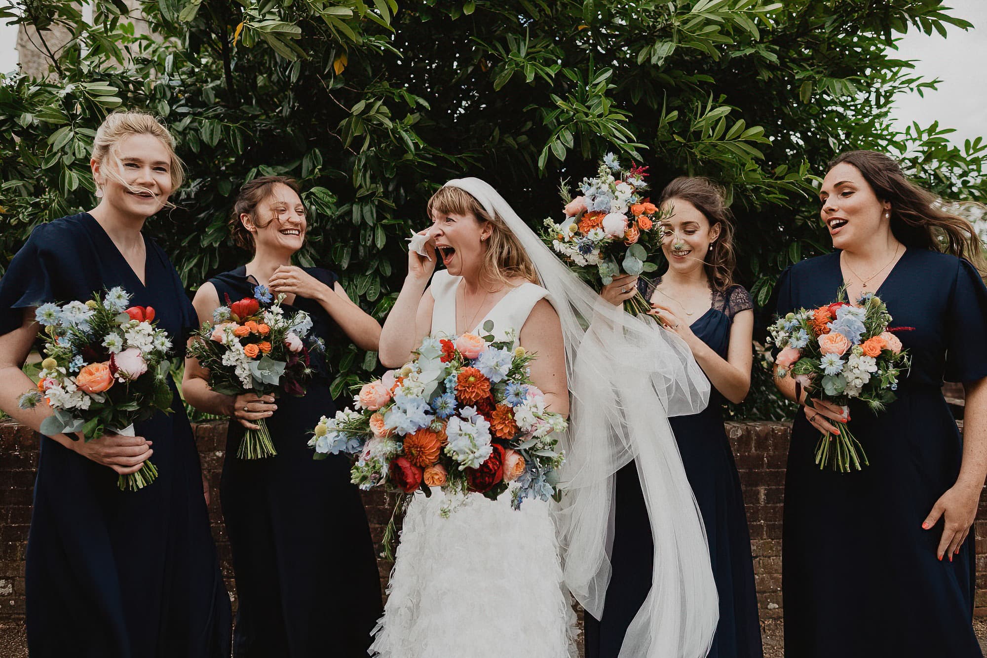 bride feeling emotional with her bridesmaids