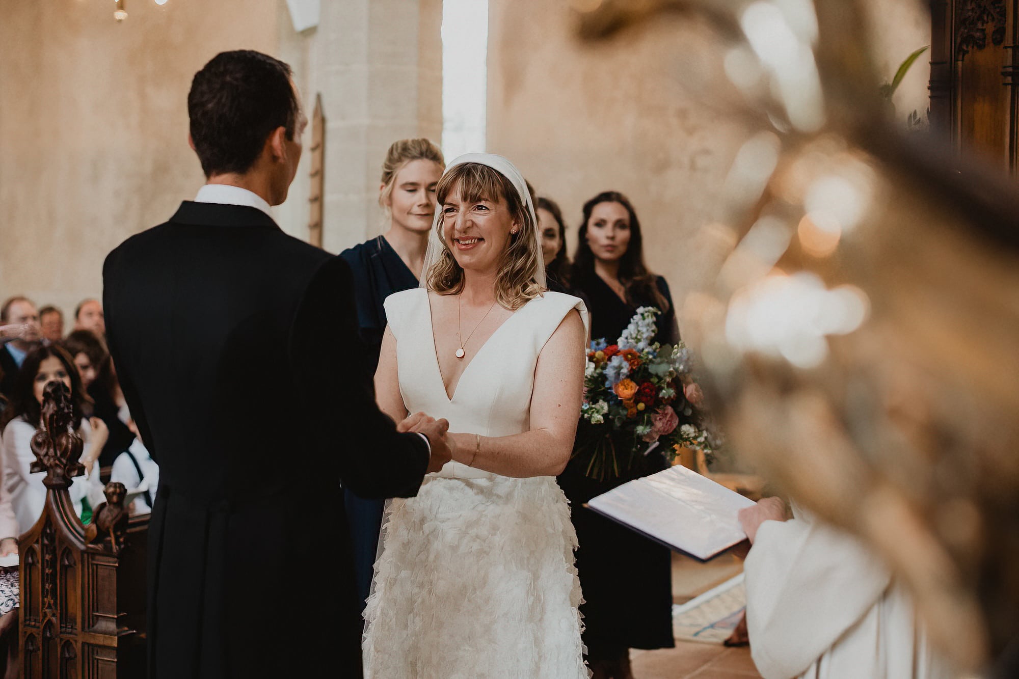 bride and groom exchanging vows in woolpit church