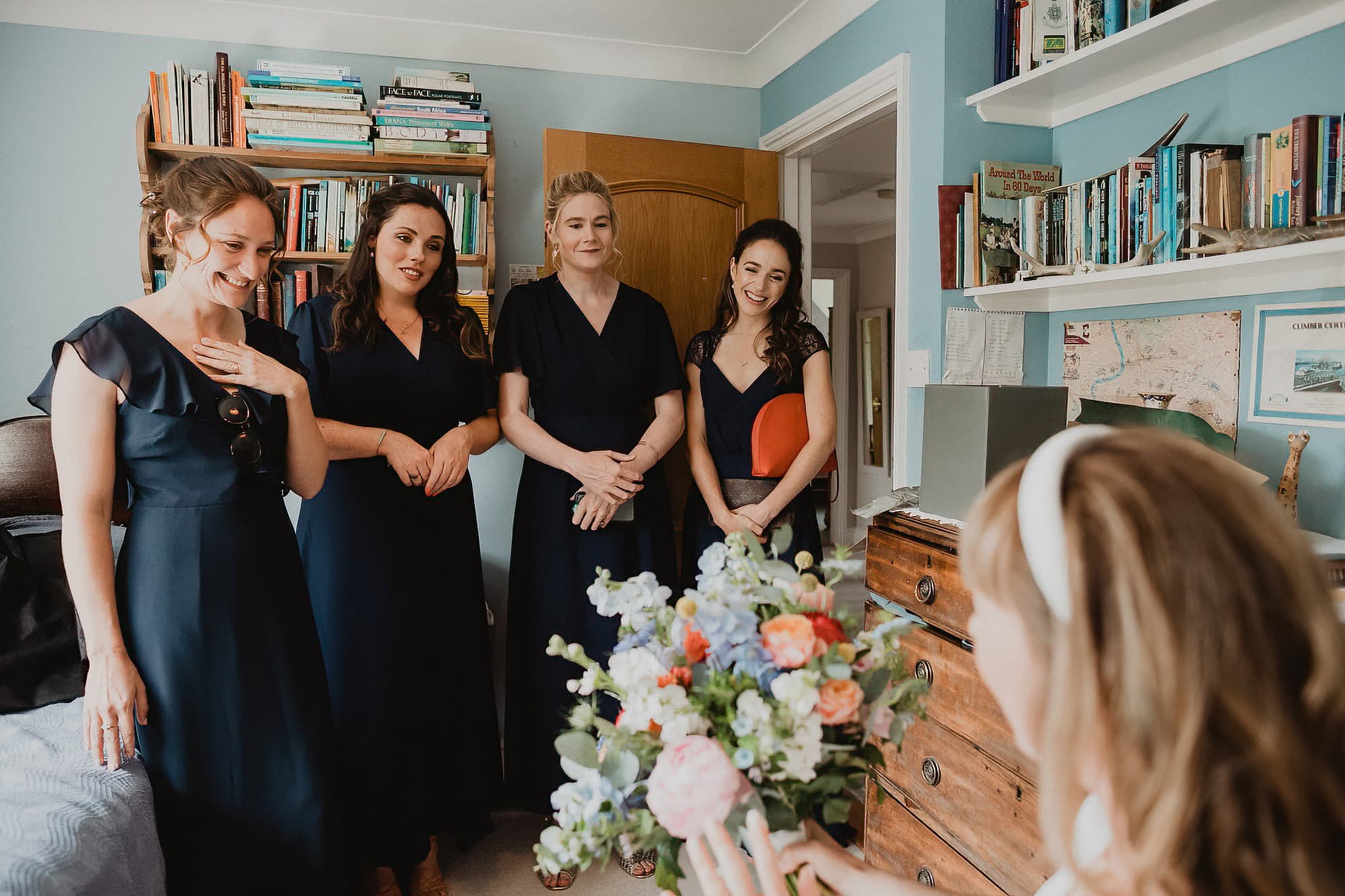 bridesmaids seeing bride ready for the first time