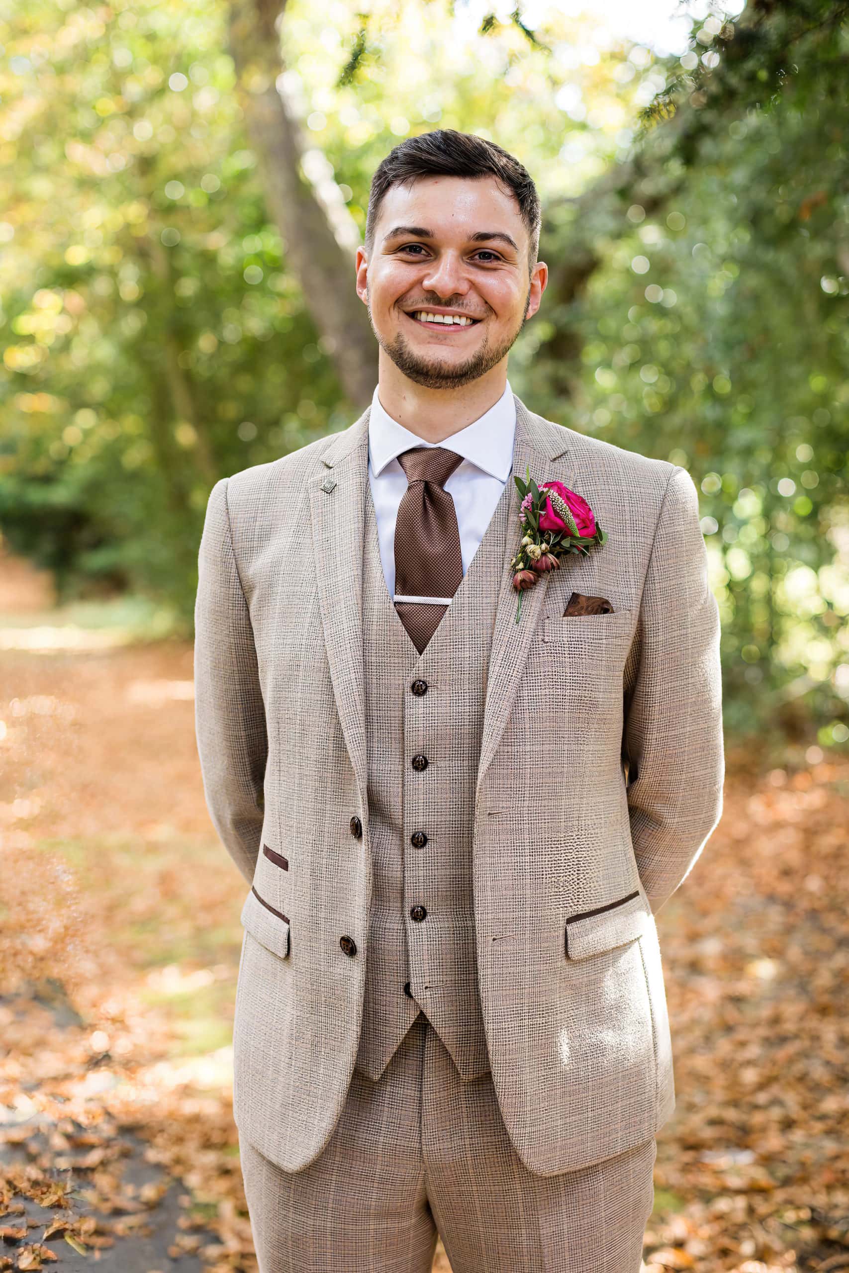 groom in three piece check suit