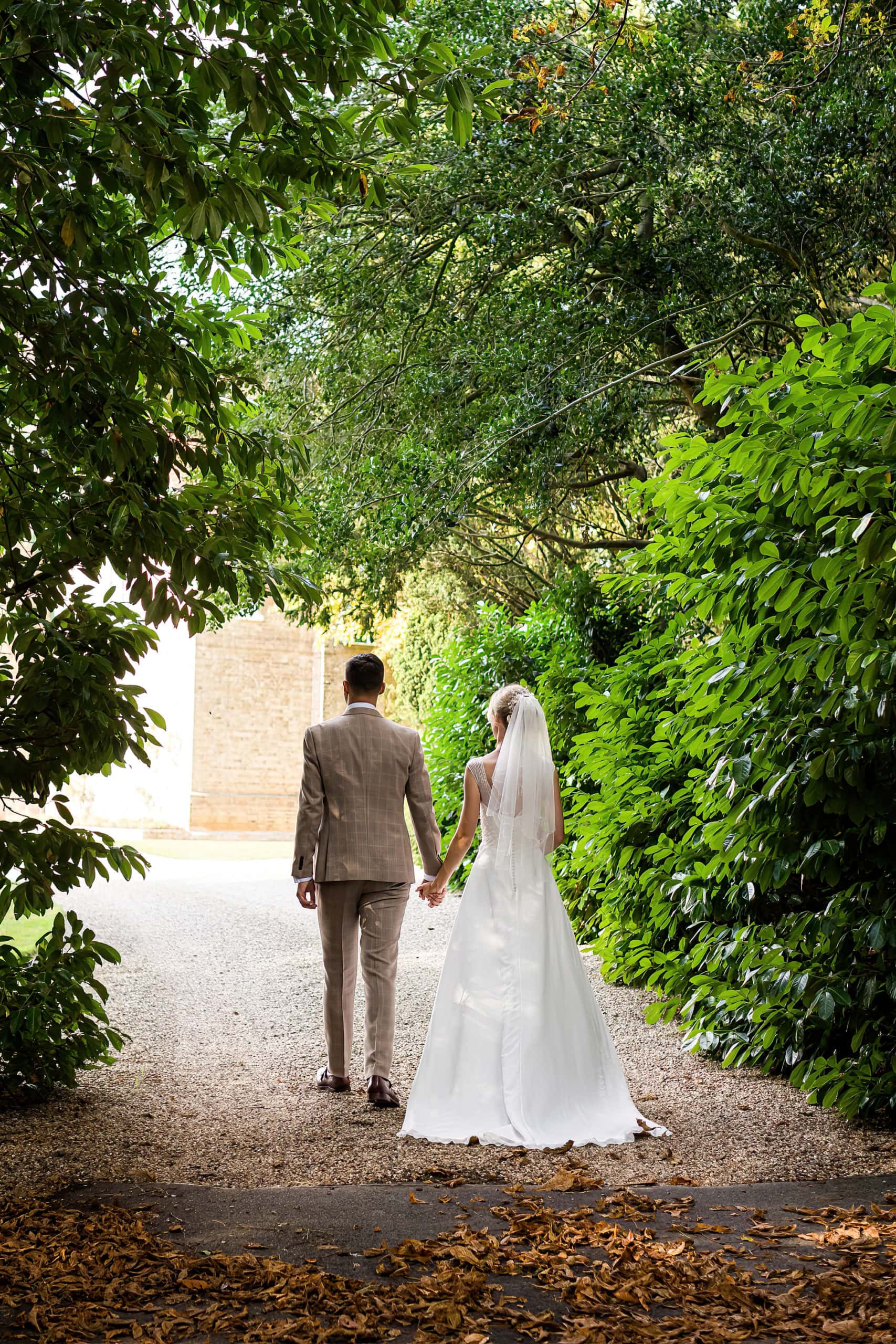 bride and groom walking at smeetham hall barn