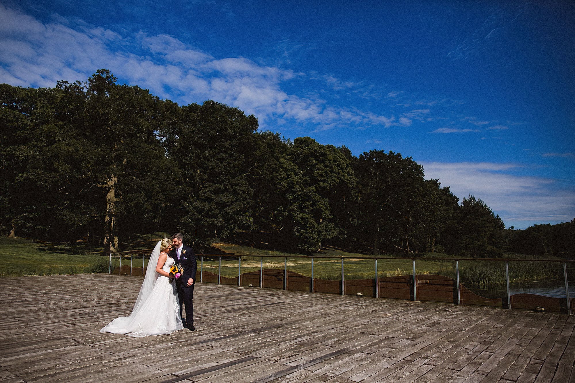 bride and groom on iconic bridge in henham park