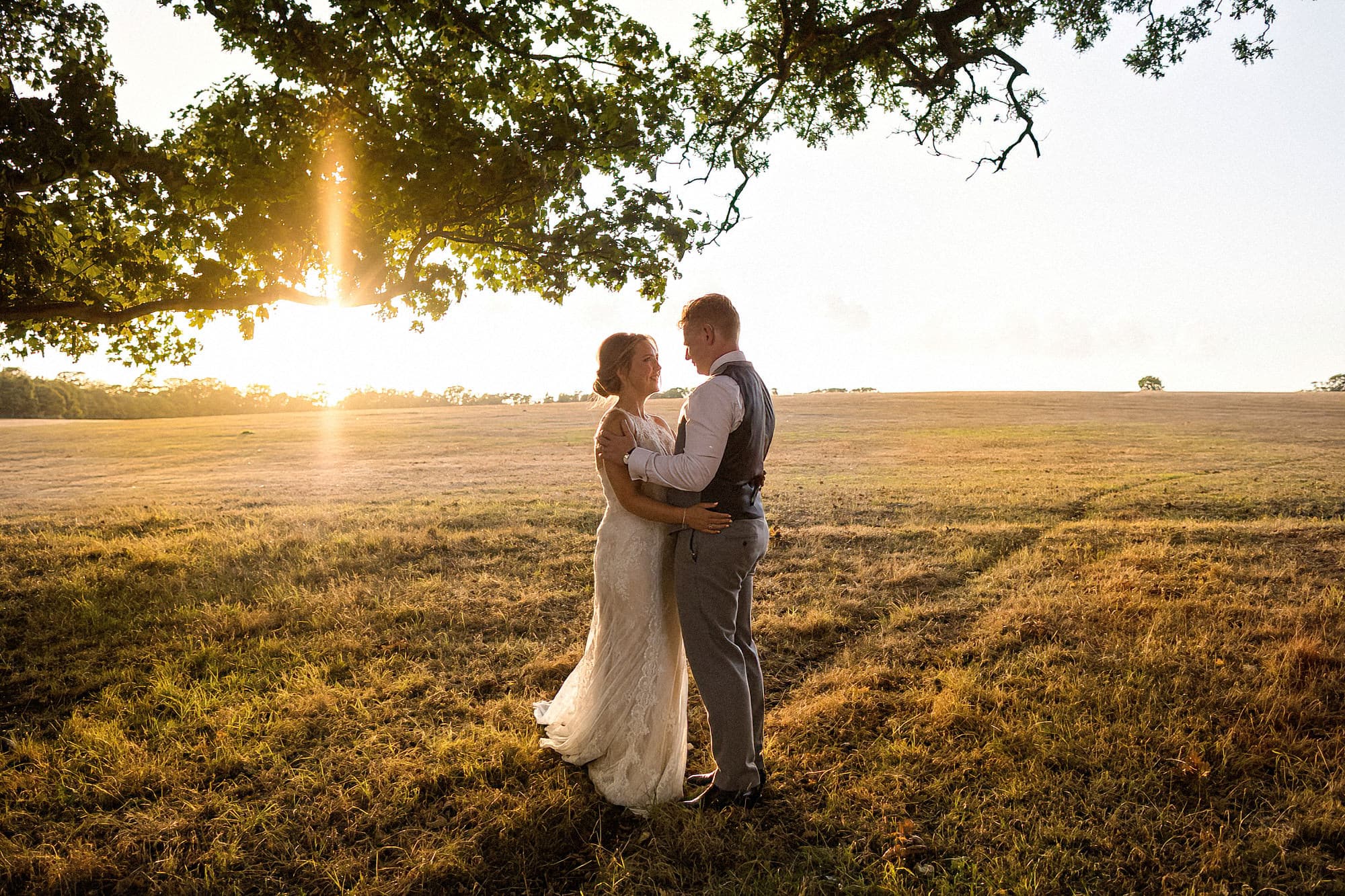 bride and groom in parklands at henham park at golden hour