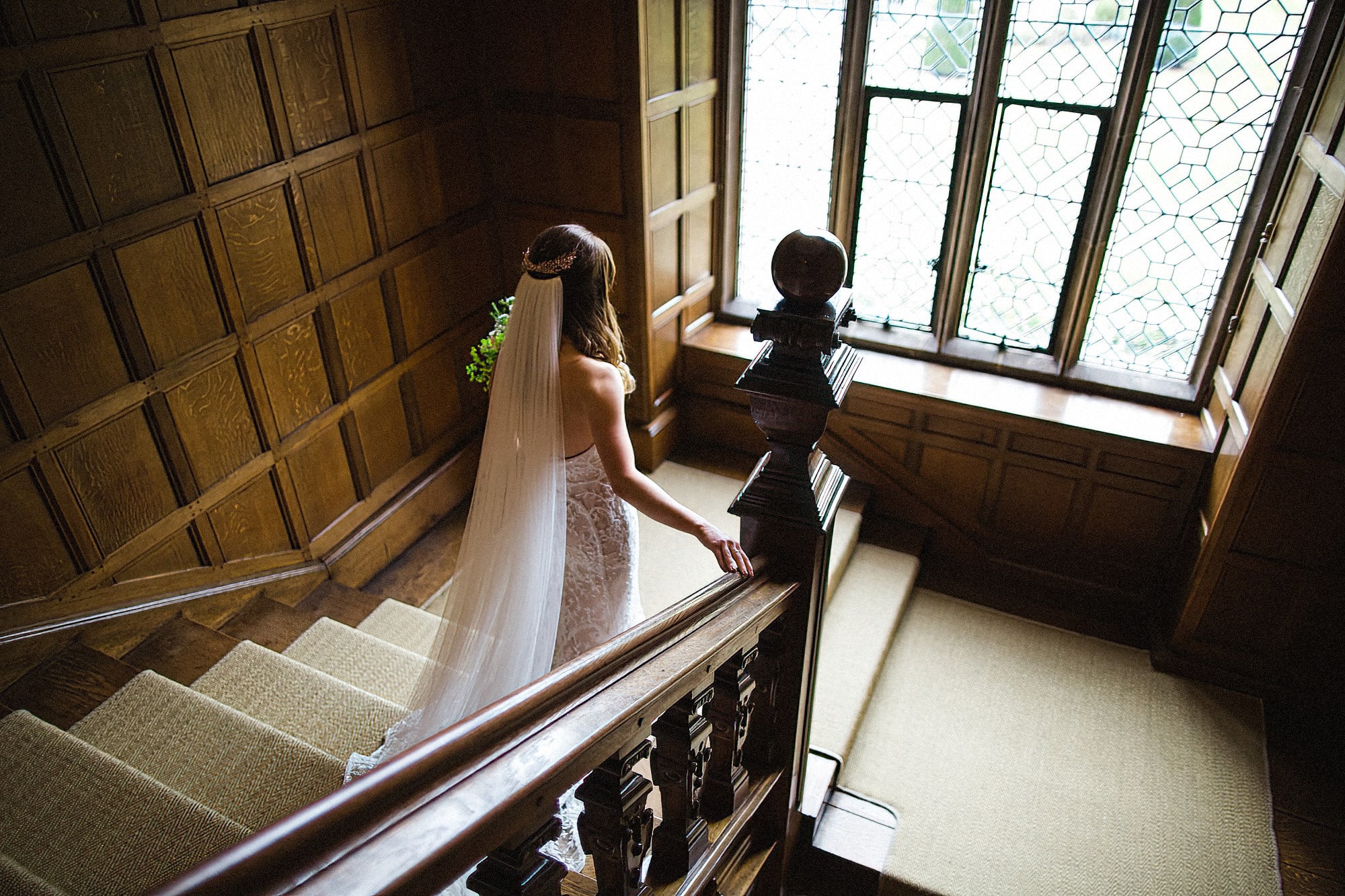 bride walking down the stairs at hengrave hall