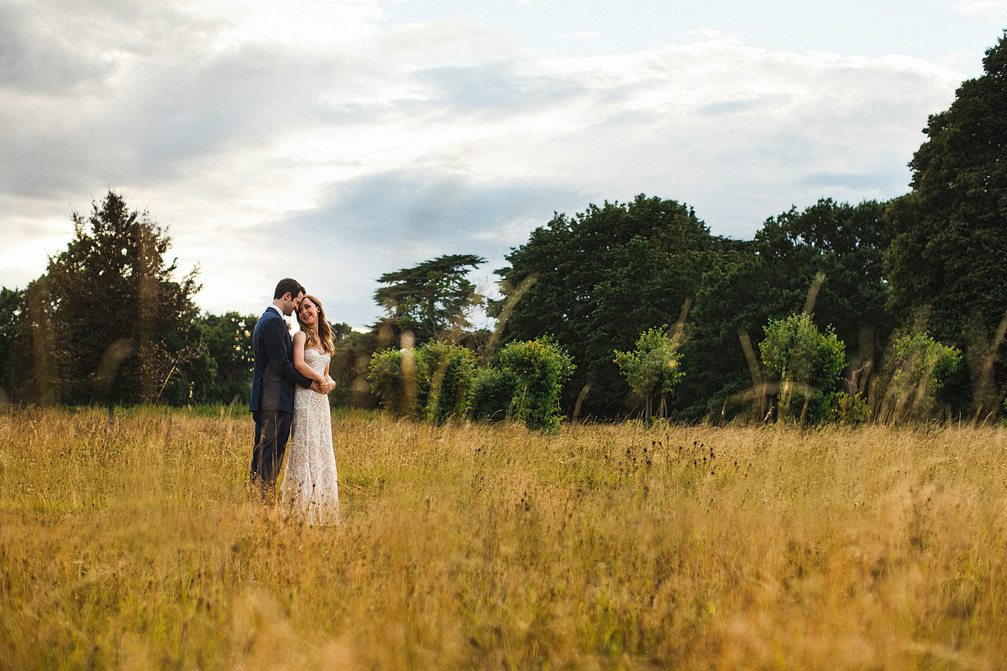 bride and groom in the grounds at hengrave hall