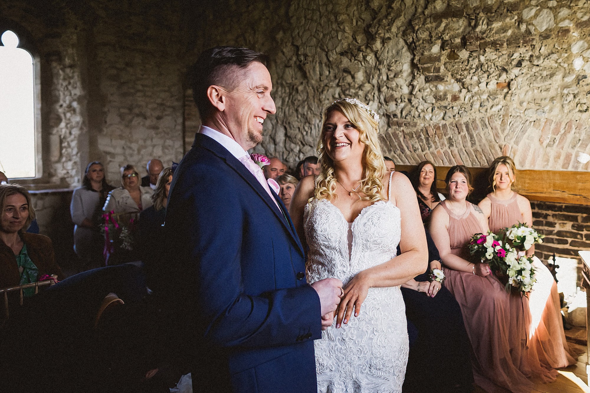 bride and groom exchanging vows at pentney abbey
