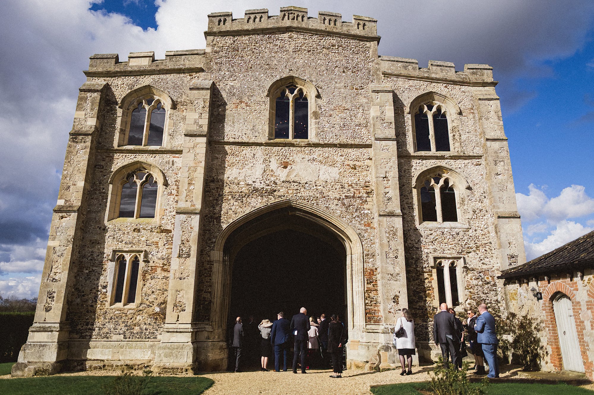 guests standing outside pentney abbey at drinks reception