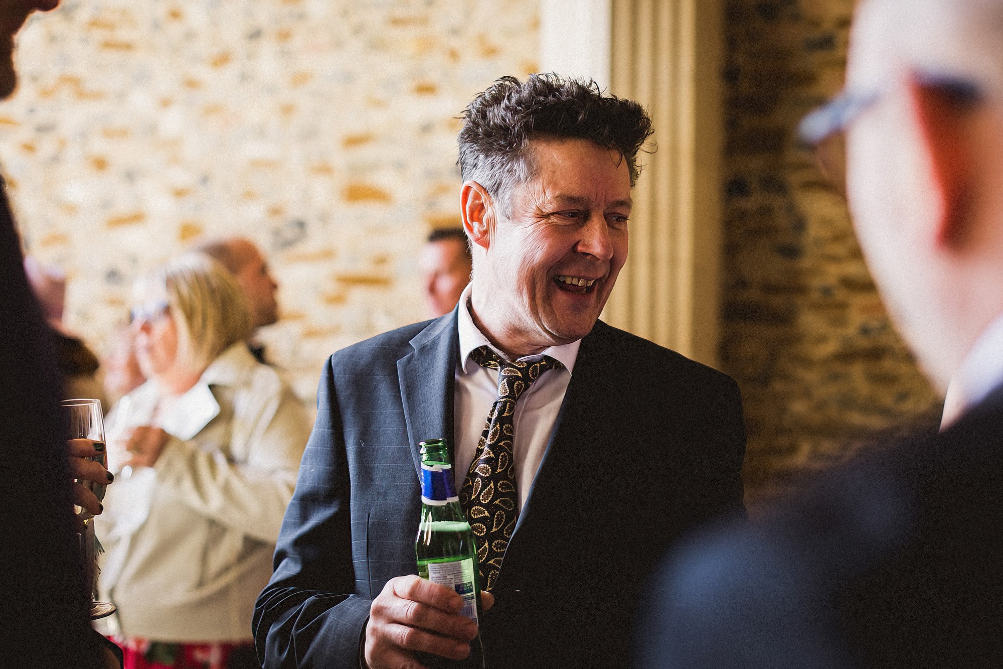wedding guest laughing at pentney abbey wedding reception