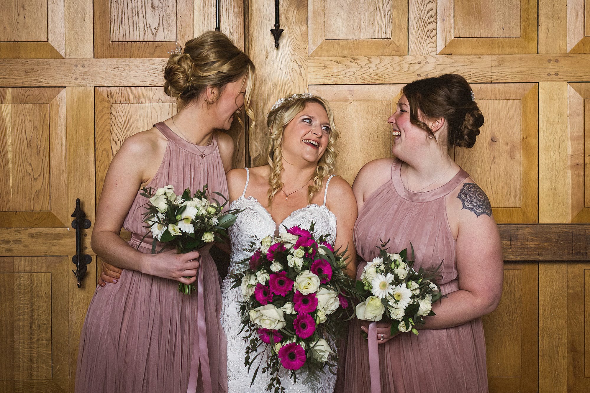 bridemaids and bride laughing whilst having a photo taken