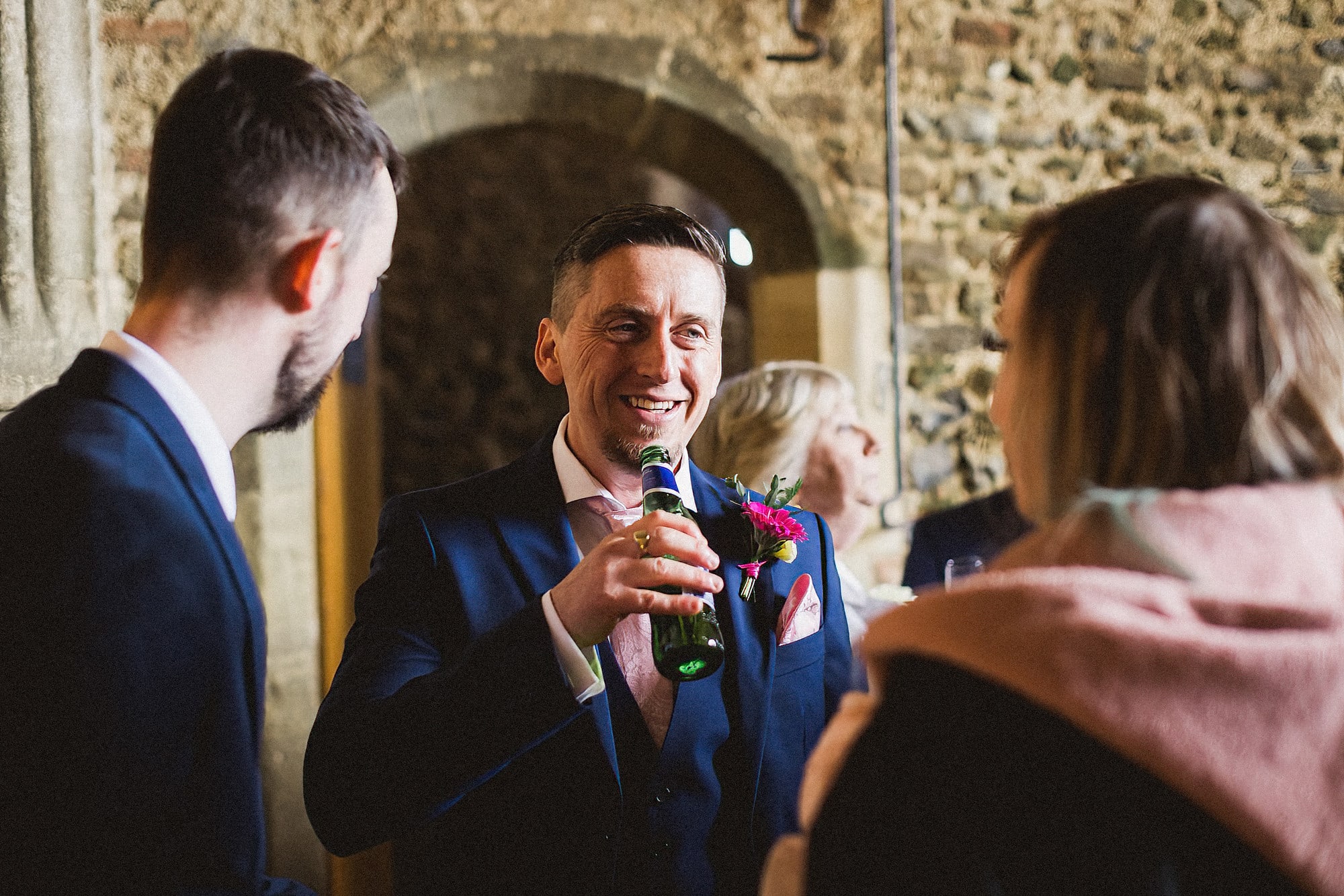 groom laughing at pentney abbey wedding reception