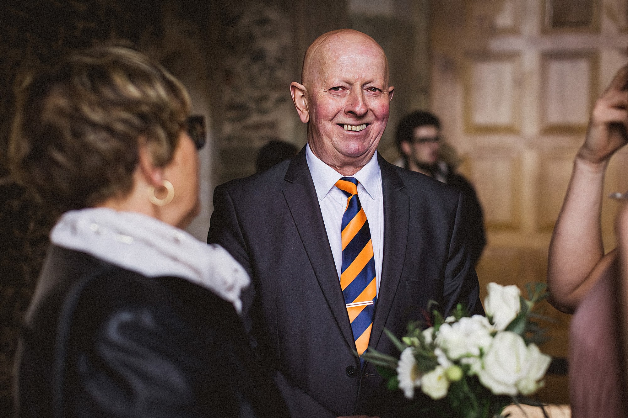 wedding guest laughing at pentney abbey wedding reception