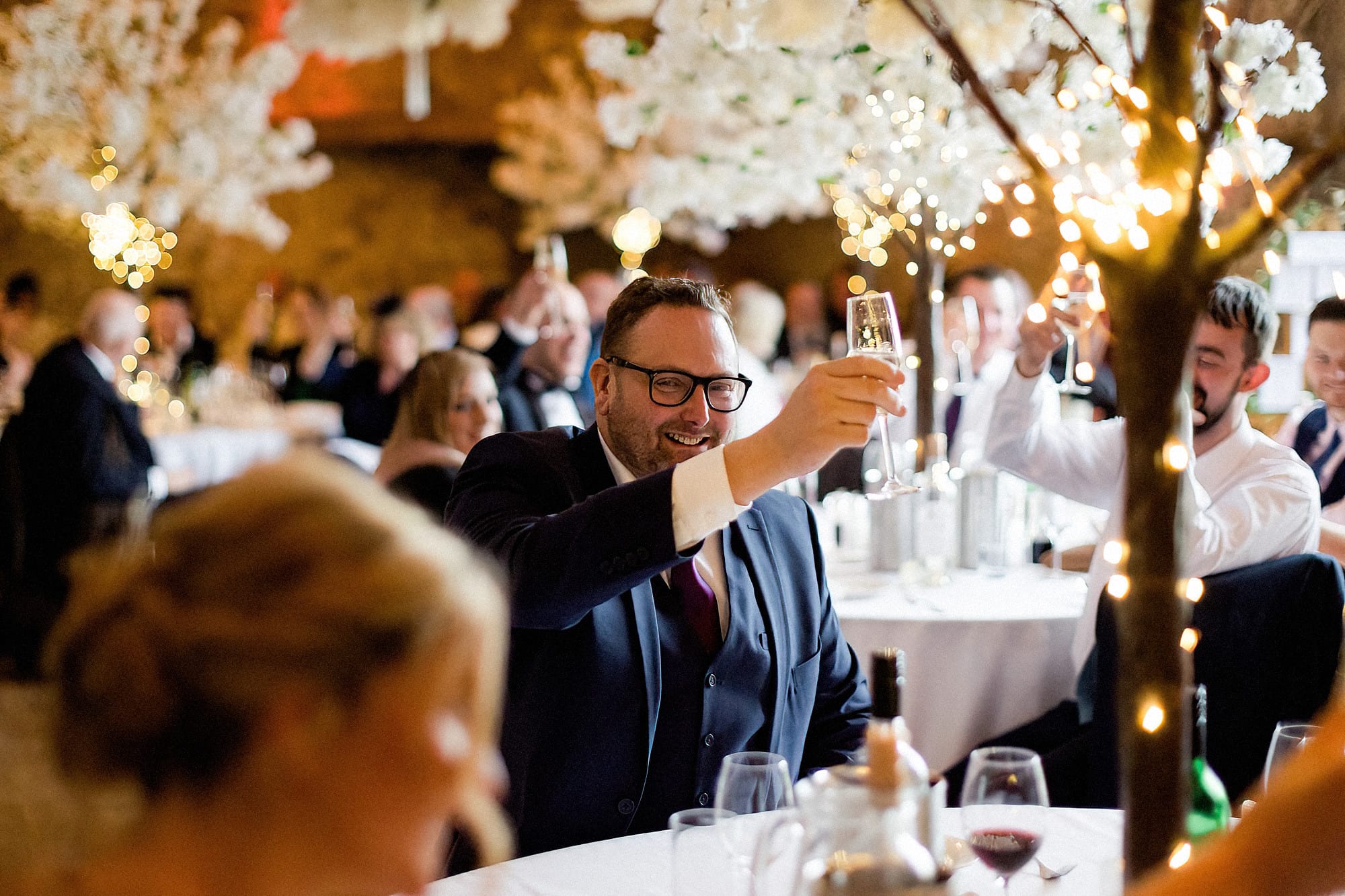 guest raising a toast to bride and groom