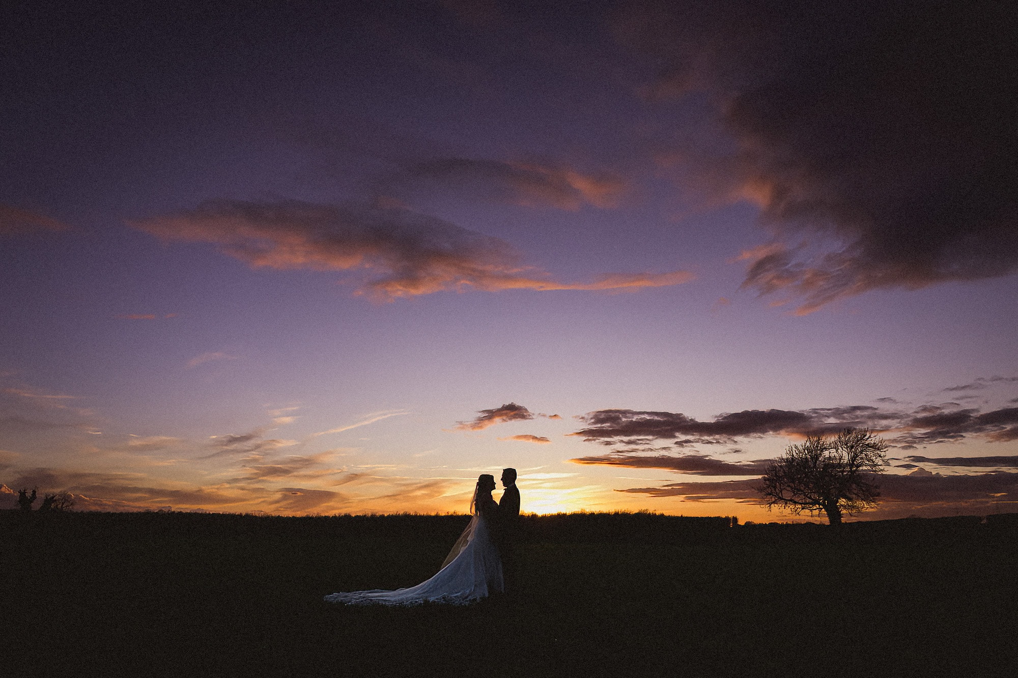 bride and groom facing each other at sunset pentney abbey