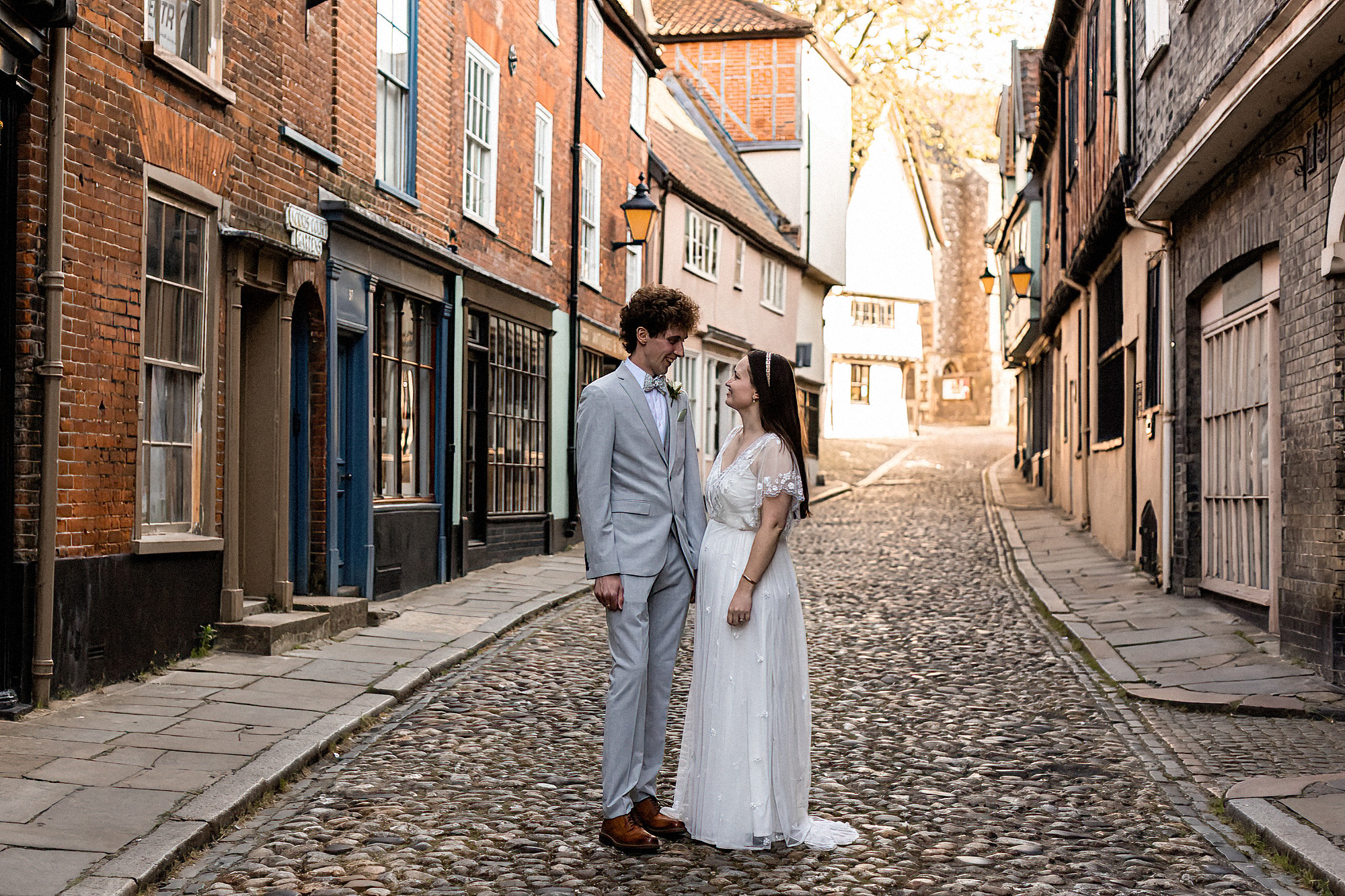 bride and groom standing posing for photo on elm hill norwich