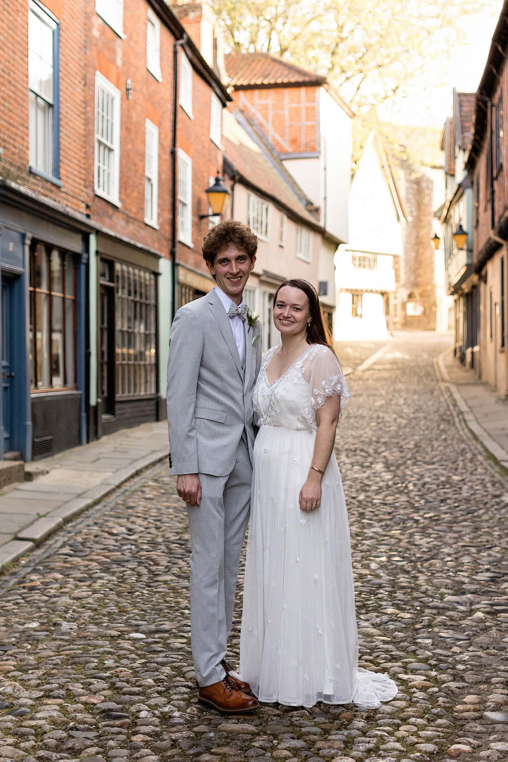 bride and groom standing posing for photo on elm hill norwich