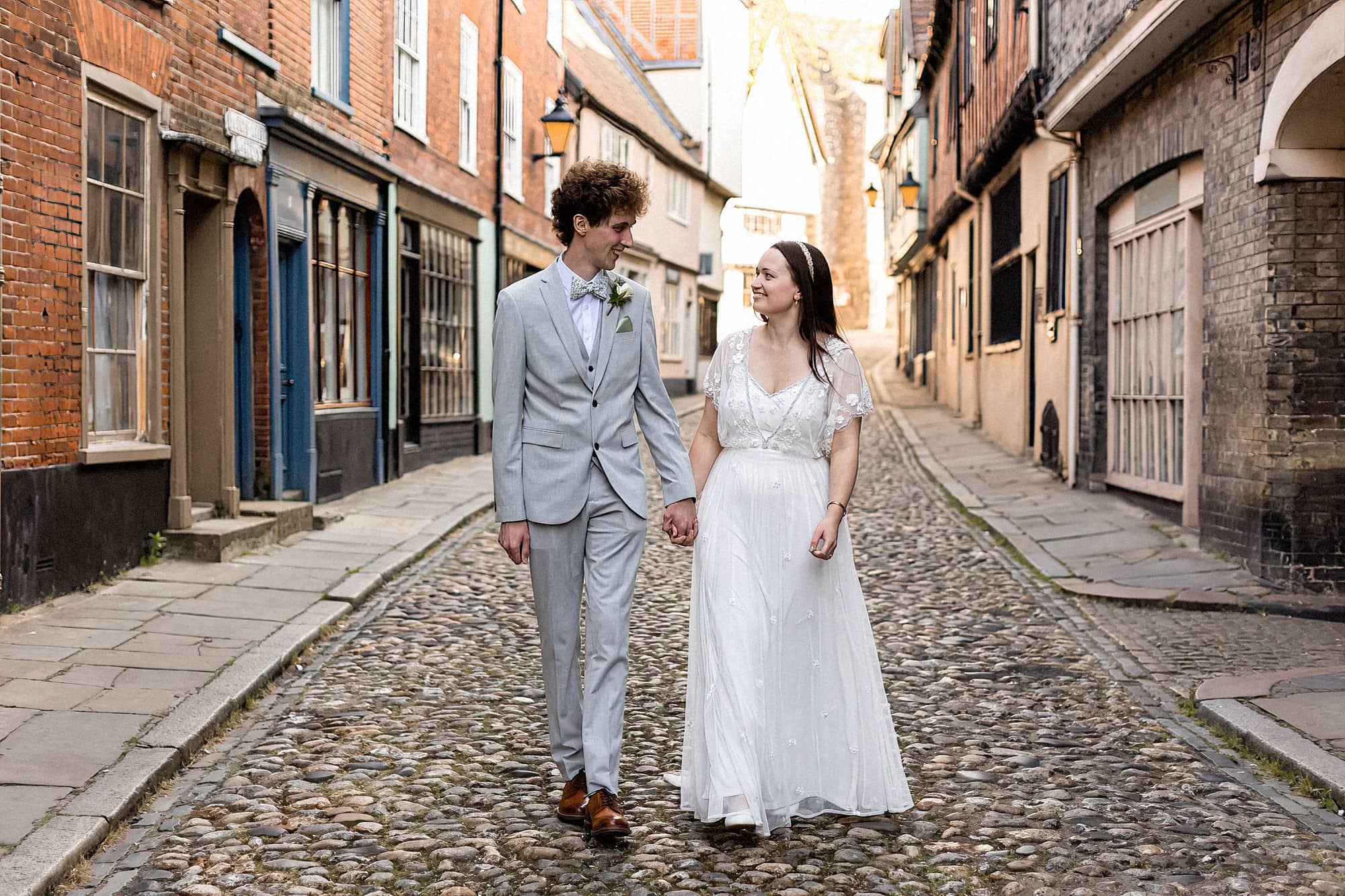 bride and groom walking hand in hand elm hill norwich