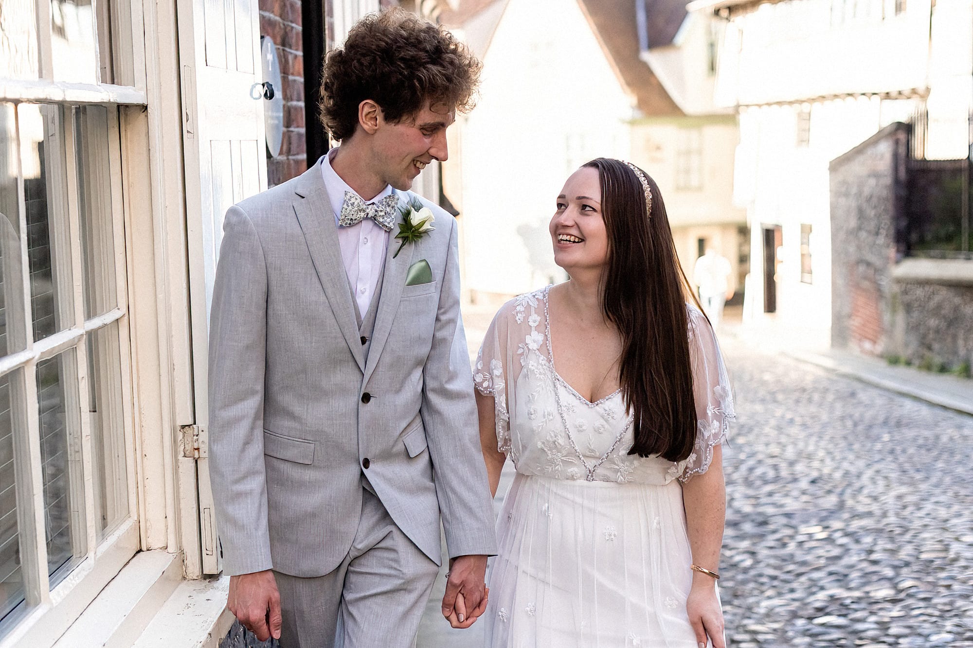 bride and groom walking hand in hand on elm hill norwich