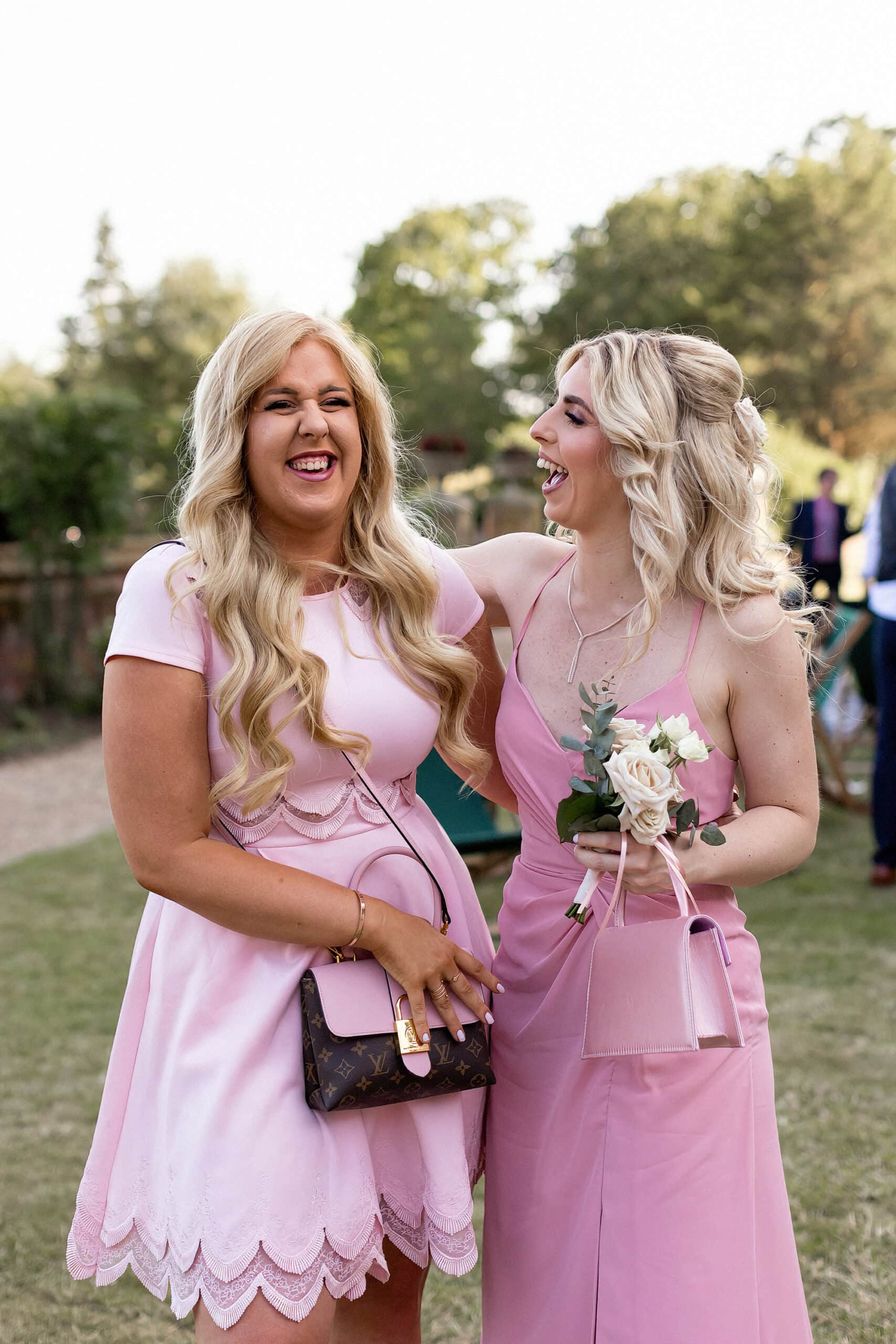 wedding guest and bridesmaid laughing