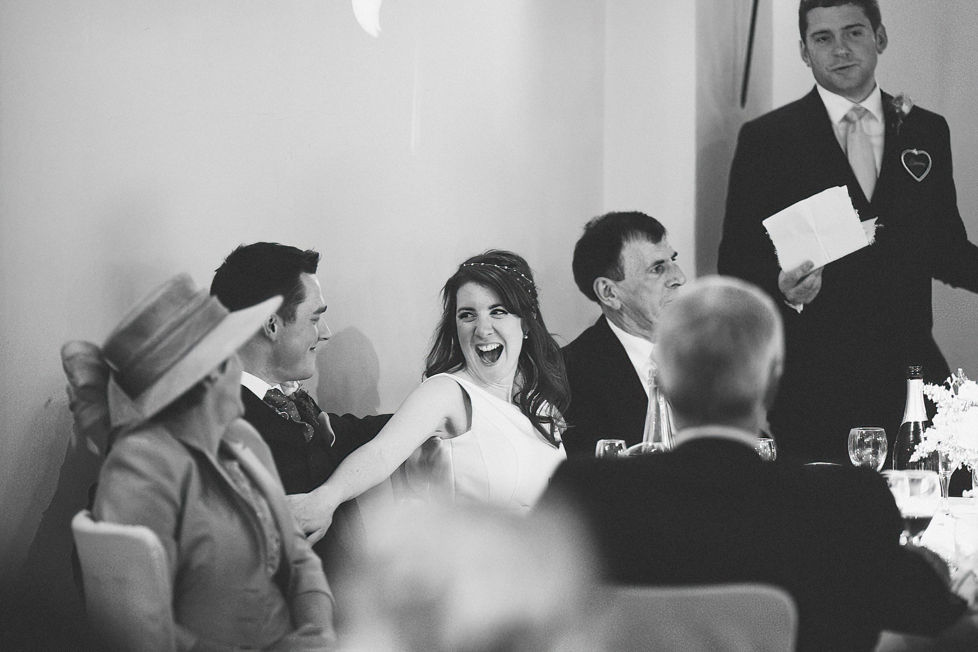bride laughing during dads speech