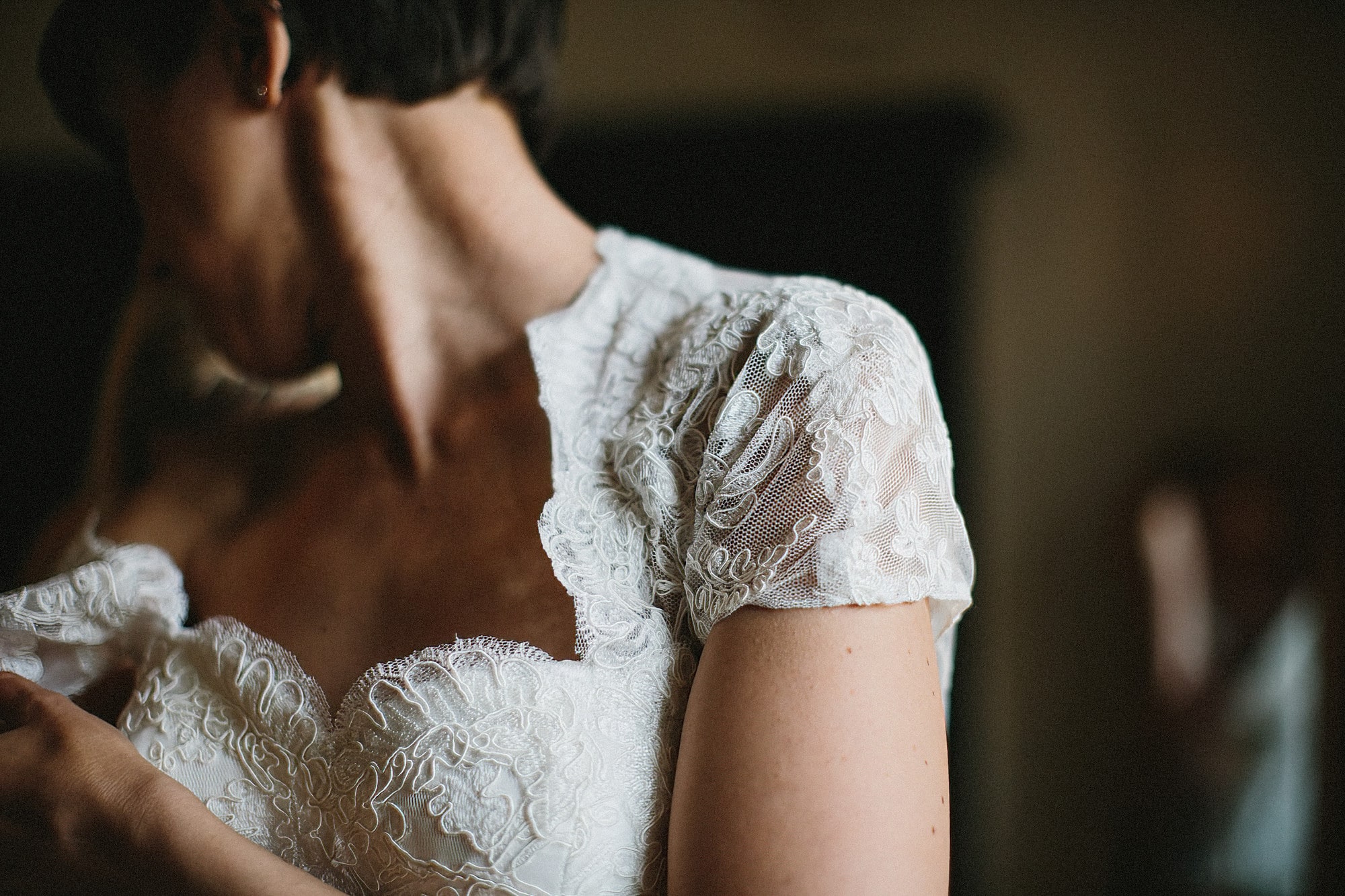 brides dress showing shoulder of lace